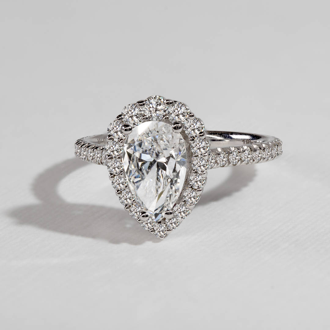 Michael M. 18k white gold setting shown with a pear-shaped center diamond