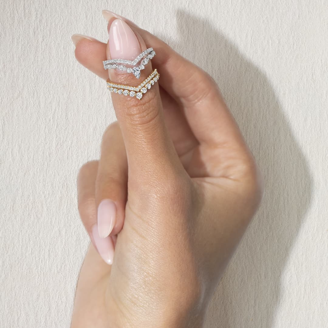 Contoured diamond wedding bands curved to trace a pear-shaped engagement ring
